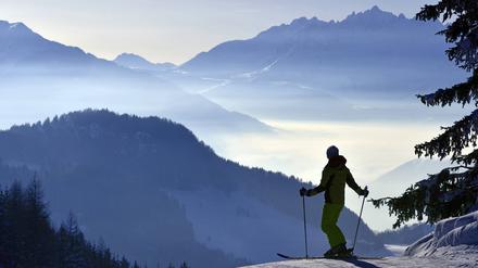 Ein Skifahrer bewundert die verschneite Bergkulisse im französischen La Plagne.