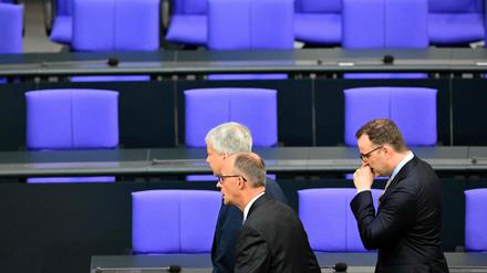 Designated Chancellor Friedrich Merz (2nd R) reacts to the result of the first round of the voting and leaves the plenary hall with the parliamentary group leader of Germany’s Christian Democratic Union (CDU) Jens Spahn (R) during a session at the Bundestag (lower house of parliament), as MPs are to elect Germany’s next Chancellor, in Berlin on May 6, 2025. (Photo by Tobias SCHWARZ / AFP)
