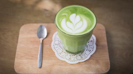 green tea latte on wood background