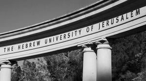 JERUSALEM, ISRAEL - FEBRUARY 19, 2014: The Hebrew University of Jerusalem sign on the arch of the amphitheater at Mount Scopus (Har Ha-Tzofim) campus. Mount Scopus campus was inaugurated in 1925. Black and white photo.