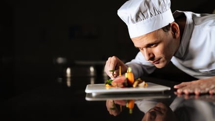 Chef decorating a plate and putting the ultimate touches