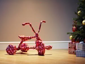 Ein als Geschenk verpacktes Dreirad.