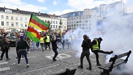 Protesters surrounded by tear gas take part in a rally gathering the Kurdish community, following the March 24 riots in Heusden-Zolder, in Brussels on March 25, 2024. (Photo by ERIC LALMAND / Belga / AFP) / Belgium OUT