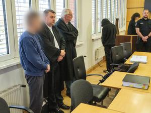 Die zwei Angeklagten (1. und 4. von links) stehen neben den zwei Verteidigern, Steffen Gerth (2.v.l) und Peter Hakert (3.v.l) vor Prozessbeginn im Sitzungssaal des Landgerichts Stralsund.