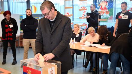 Serbiens Präsident Aleksandar Vucic wirft seinen Wahlschein in eine Urne. 