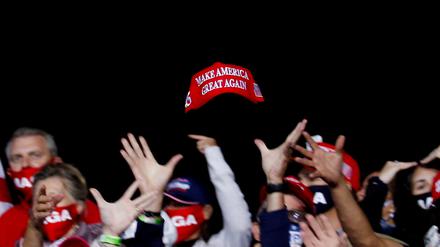FILE PHOTO: U.S. President Donald Trump supporters try to catch a hat during a campaign event in Fayetteville, North Carolina, U.S., September 19, 2020. REUTERS/Tom Brenner/File Photo   SEARCH "AMERICA IN THE AGE OF TRUMP" FOR THE PHOTOS.