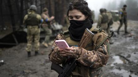 Die ukrainische Soldatin Dascha (22) überprüft ihr Telefon. 