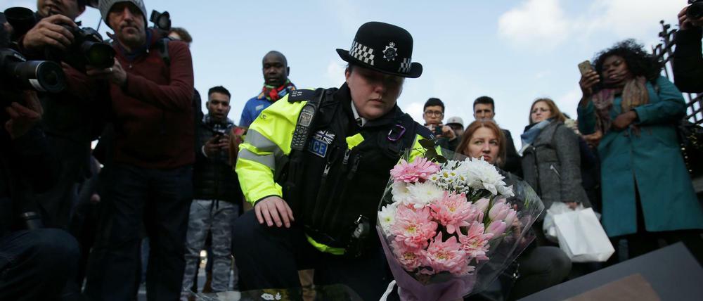 Stilles Gedenken. Eine Polizistin legt Blumen am Tatort nieder.