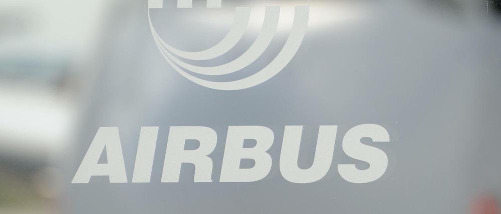 Hinter dem Logo des Flugzeughersteller Aibus ist am Airbus Standort das Cockpit eines "A380" zu sehen. 