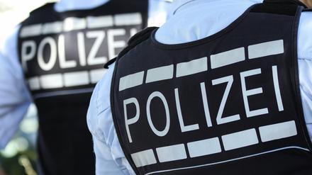 In Westen gekleidete Polizisten stehen in Baden-Württemberg (Symbolbild).