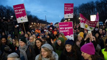 Teilnehmer an der Tanz-Demo "One billion Rising Revolution" stehen am Brandenburger Tor.