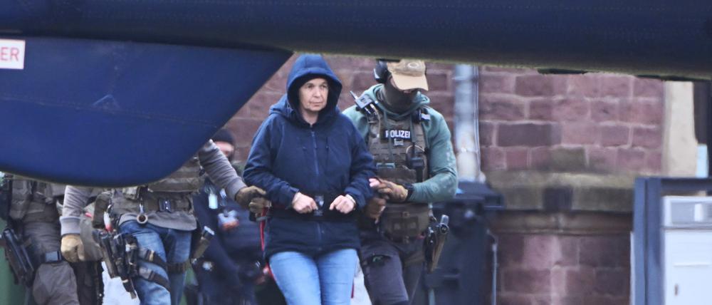 Im Innenhof eines Behördenzentrums wird die frühere RAF-Terroristin Daniela Klette zu einem Hubschrauber geführt. Zuvor hatte sie einen Haftprüfungstermin beim Bundesgerichtshof (BGH).