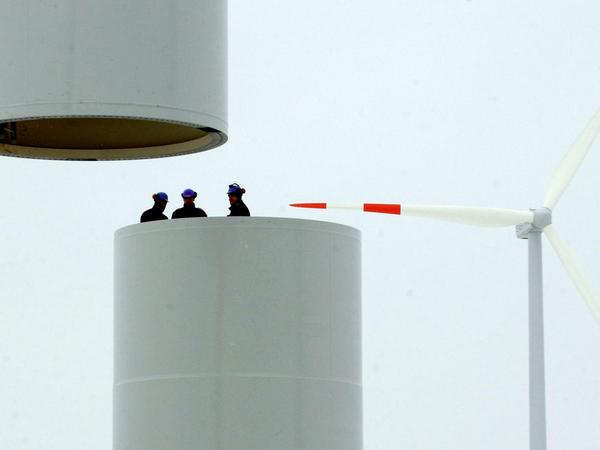 Drei Mitarbeiter der Firma Vestas stehen am Dienstag (15.02.2005) nahe Pomellen in einem Windradmast, der gerade montiert wird.