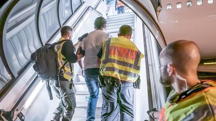 Polizeibeamte begleiten einen Afghanen auf dem Flughafen Leipzig-Halle in ein Charterflugzeug. Deutschland schiebt vorerst keine Menschen mehr nach Afghanistan ab. 