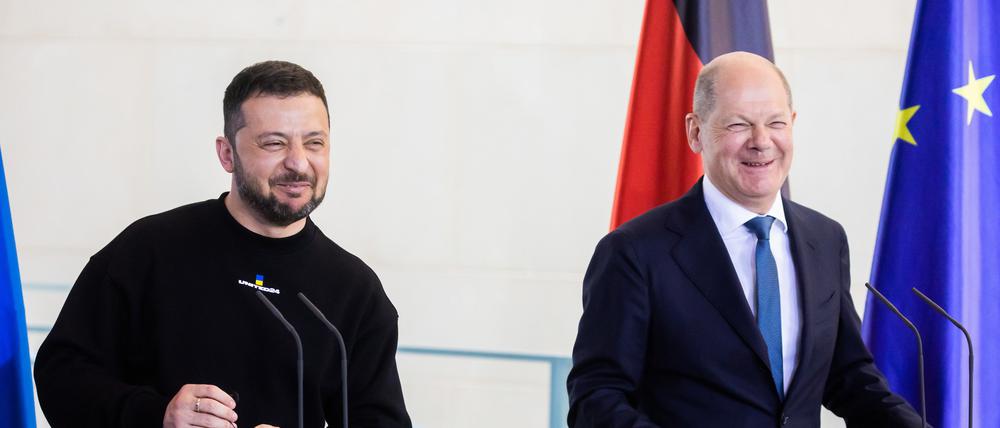 Wolodymyr Selenskyj, Präsident der Ukraine, und Bundeskanzler Olaf Scholz (r, SPD) lachen bei einer Pressekonferenz nach ihrem Gespräch im Bundeskanzleramt.