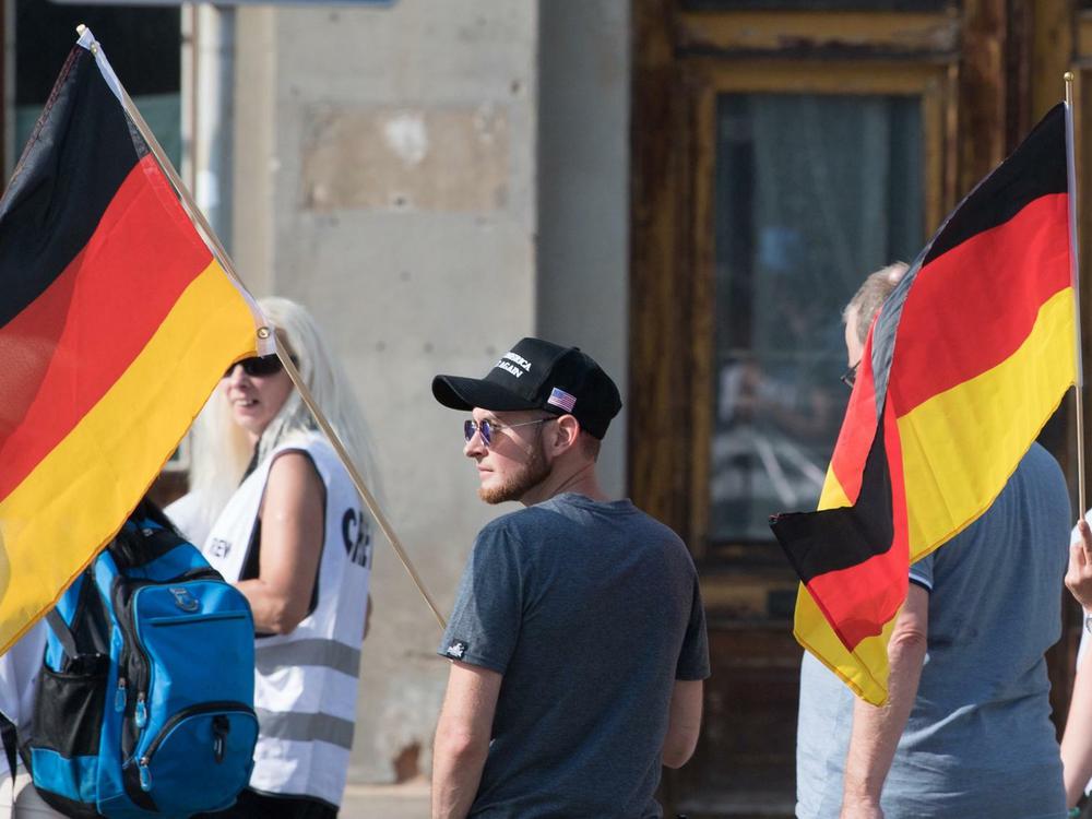 Ein Mann rollt eine AfD-Fahne aus in Goerlitz, 15.06.2019