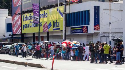 Menschen in Venezuela warten vor einem Geschäft, das verbilligte Produkte anbietet.