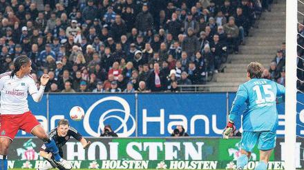 Gefahr im Anflug. Bayerns Bastian Schweinsteiger (schwarzes Trikot) schlich sich bei einer Flanke von Toni Kroos in den Rücken der Hamburger Abwehr und überwand HSV-Torwart René Adler (rechts) zur Münchener Führung. Foto: dpa