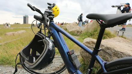 Zwei Helme hängen an einem Fahrrad, das auf dem Brocken steht. (Symbolbild)